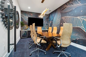 a conference room with a wooden table and chairs